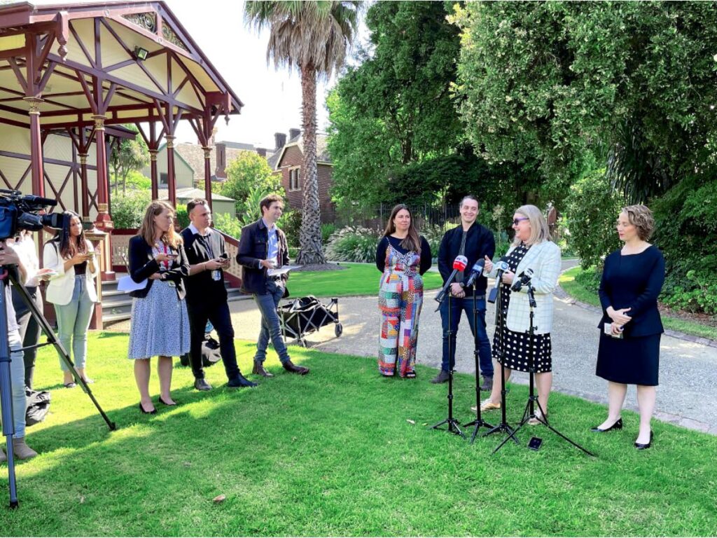 Laura Collister speaking to the media in the gardens at Melbournes Parliament House