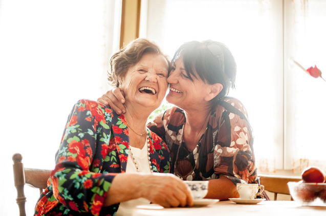 Senior Woman Enjoying a relaxing moment with her Daughter at Home drinking Coffee