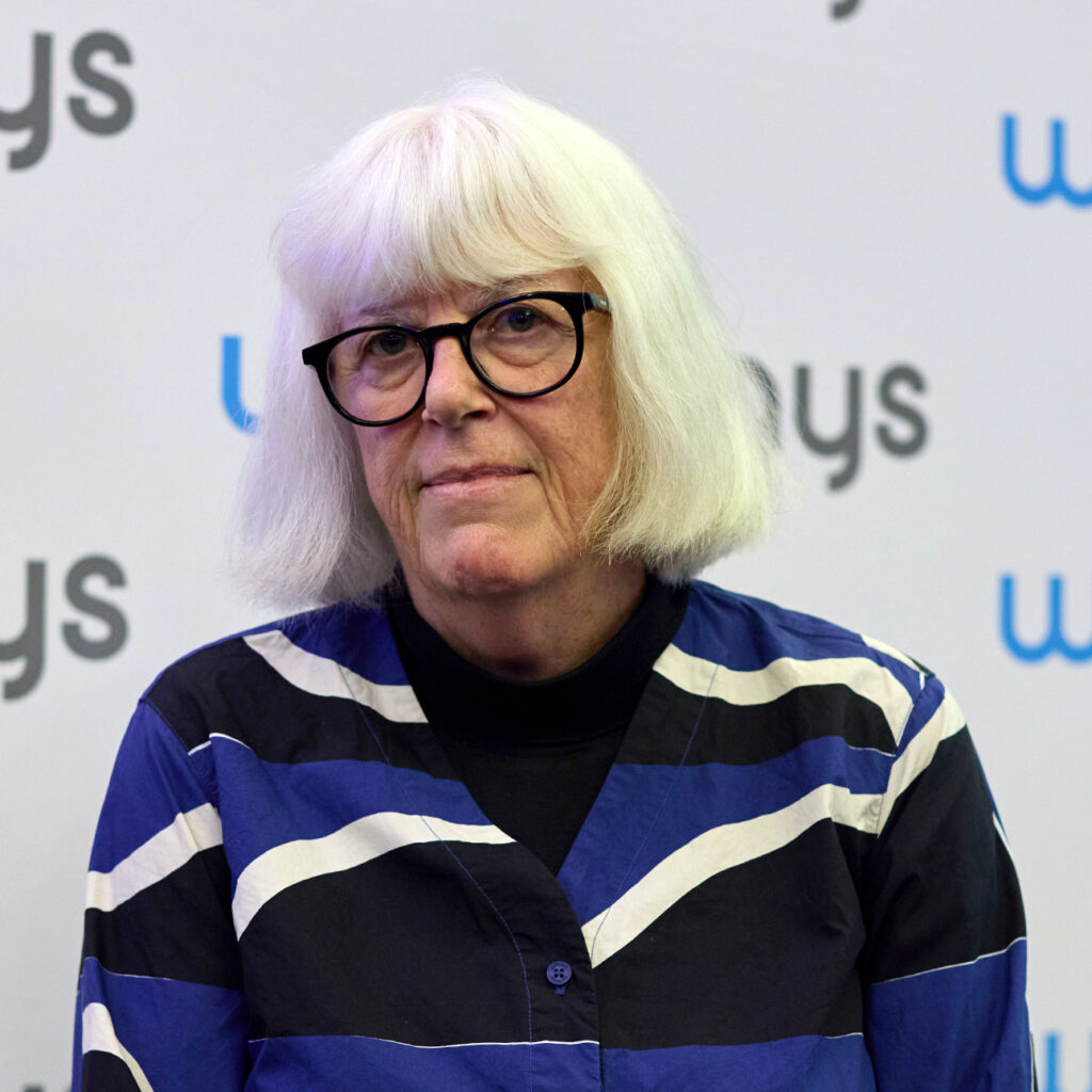 Mary O'Hagan in front of a Wellways photo wall
