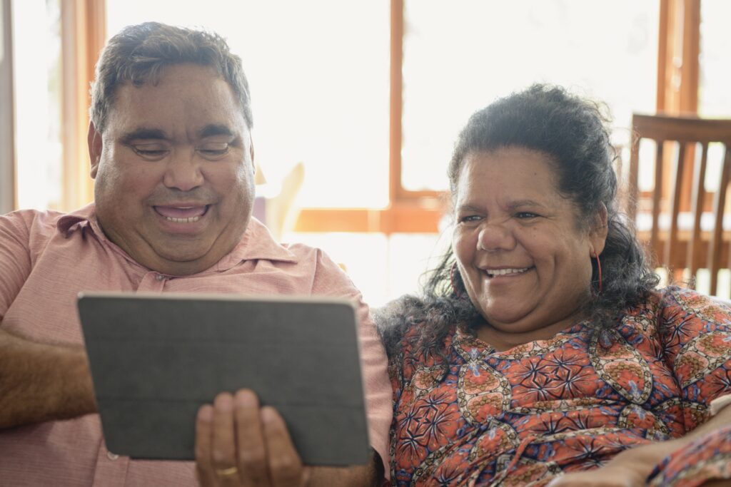 First Nations couple looking at an ipad.