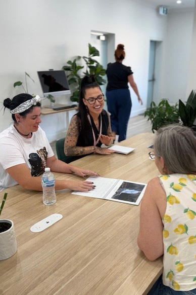 A group of people sitting at a large table observing a calendar