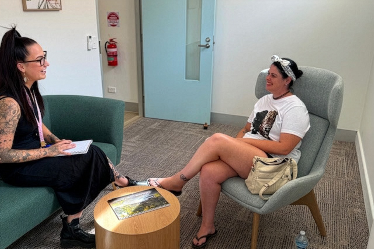 Two people sitting on lounge chairs in a consultation room