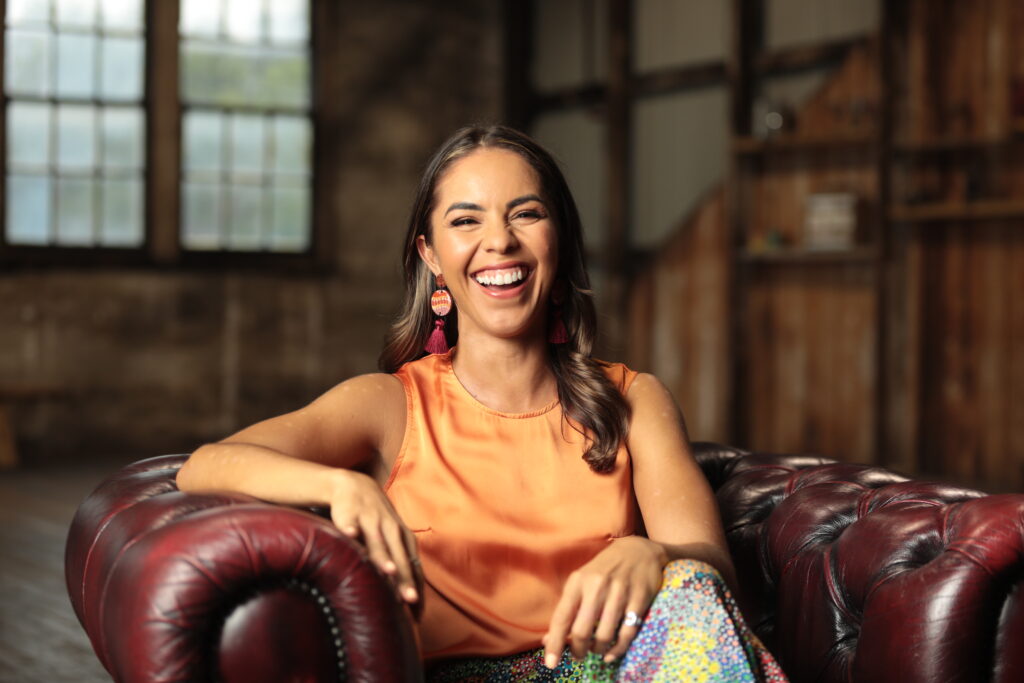 Young woman sitting on a chair smiling