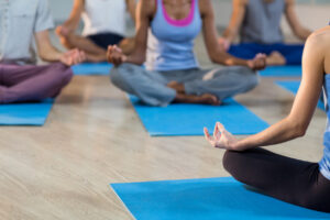 Instructor taking yoga class in fitness studio