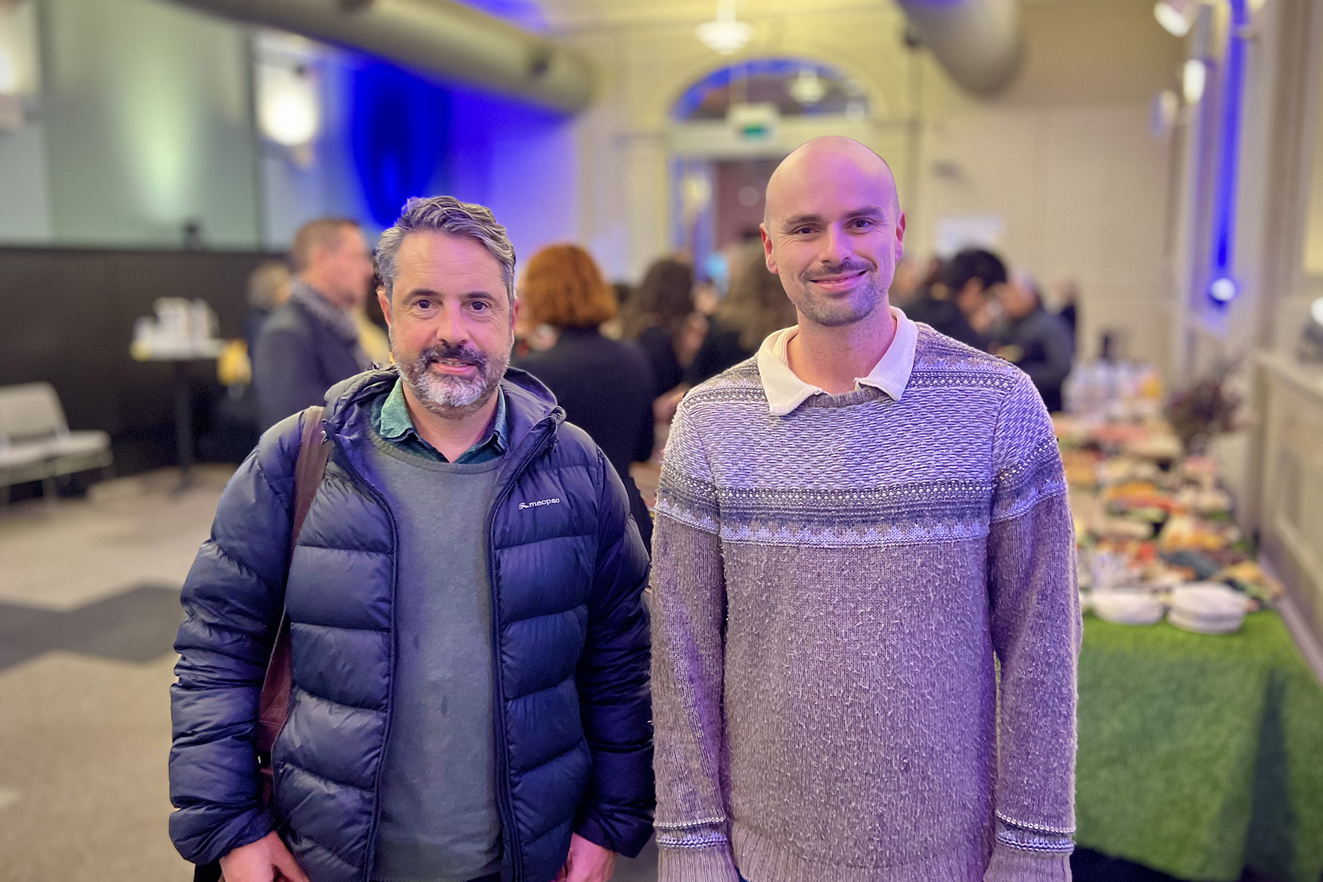 Two people posing for a photo at an event.