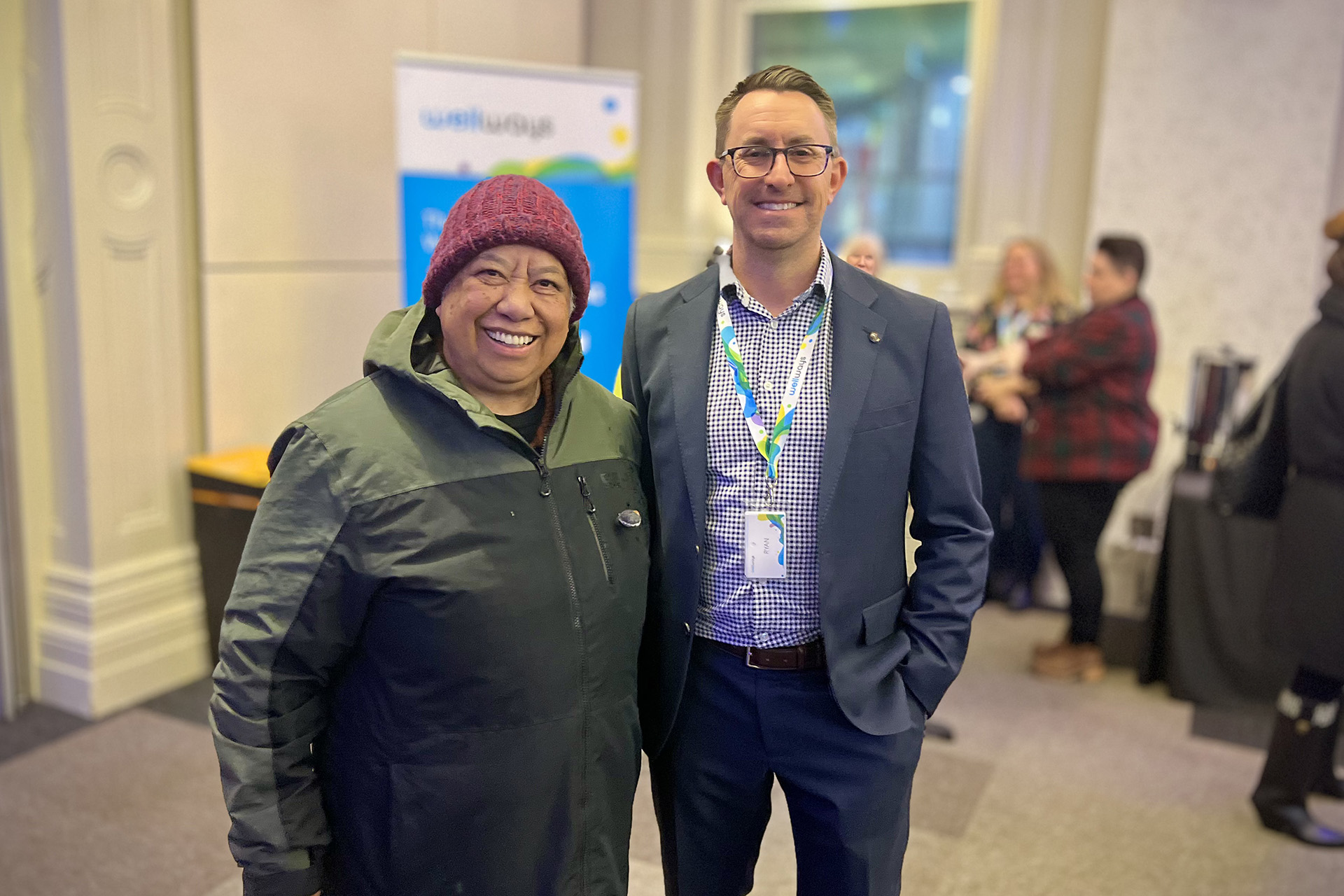Two people posing for a photo at an event.