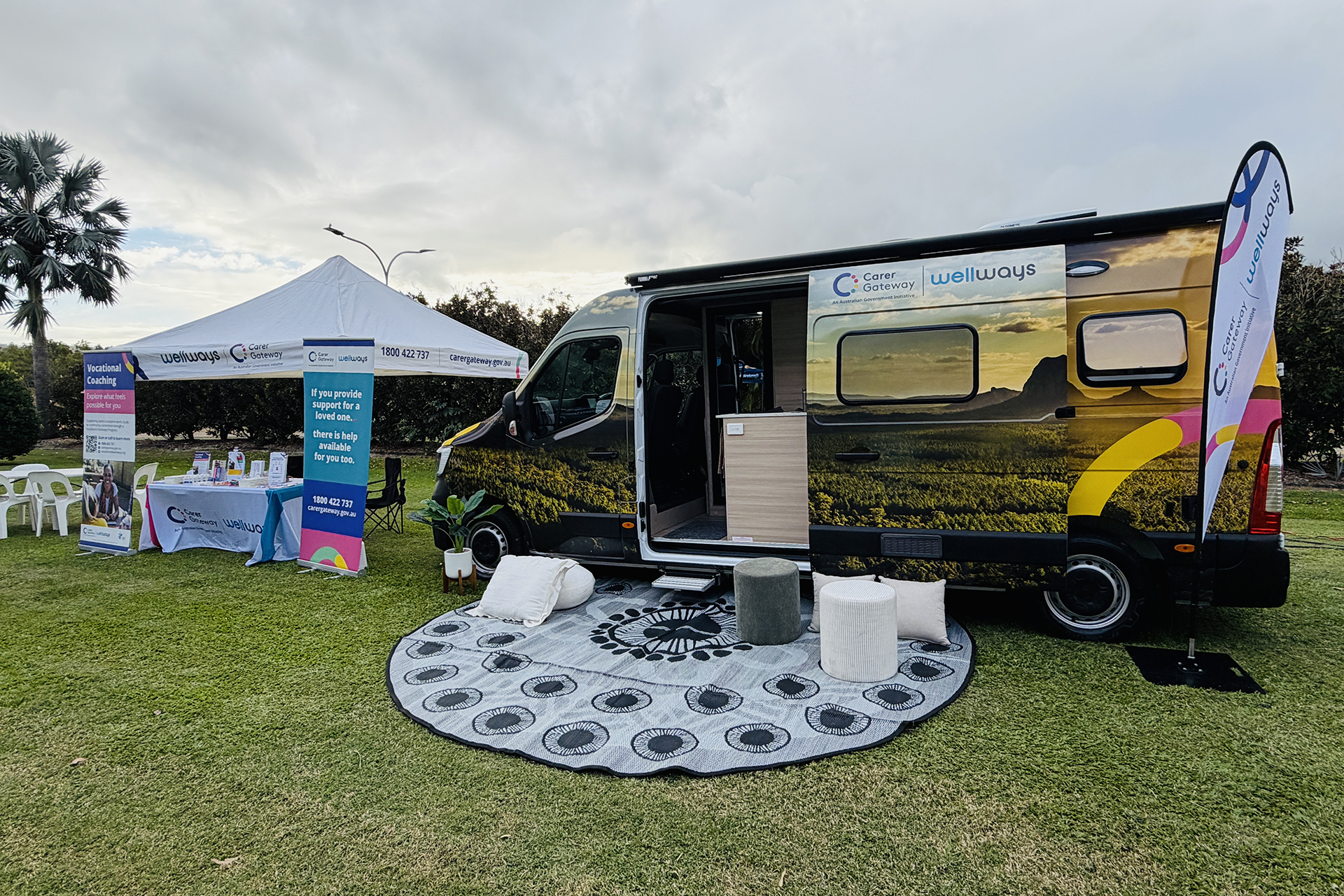 A Wellways Carer Gateway marquee and Wanda van side-by-side, set up for an event on a grass field