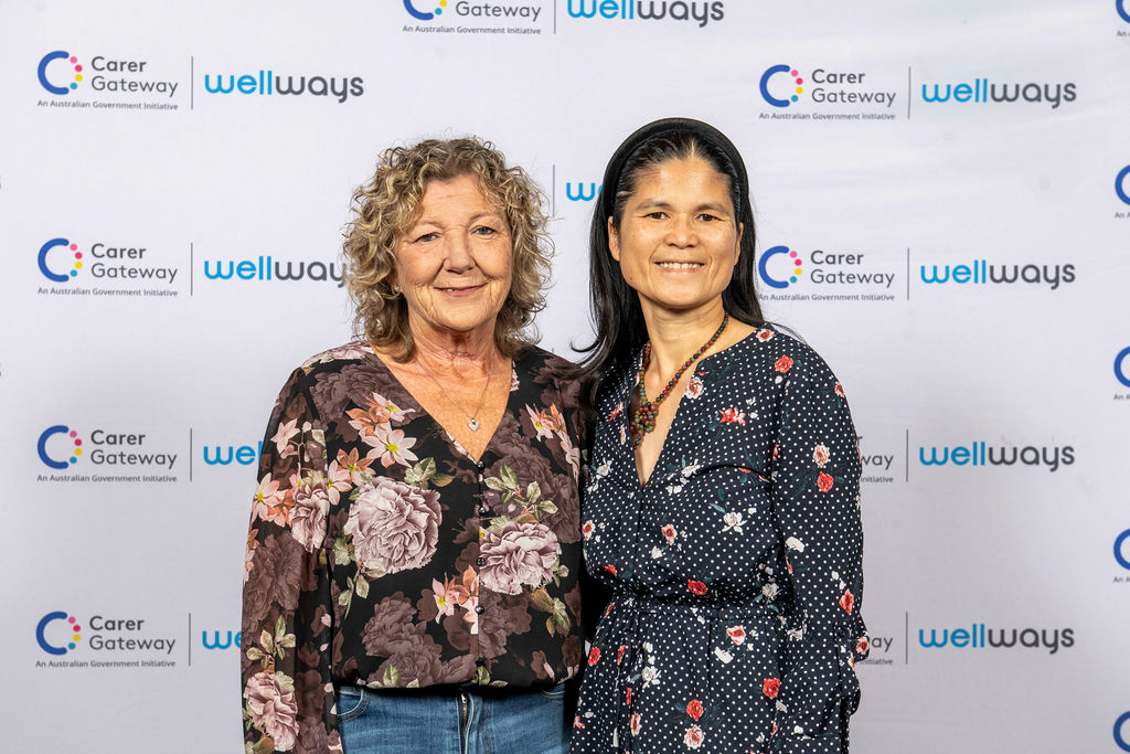 Two poeple standing and posing for a photo