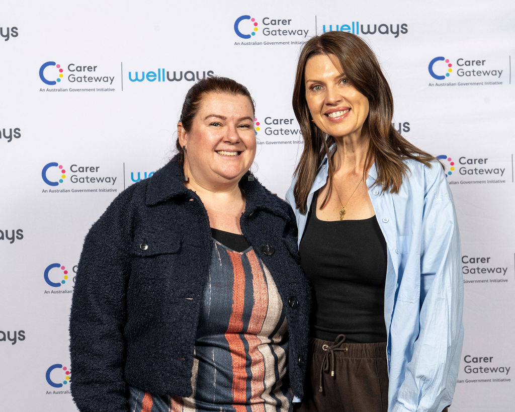Two poeple standing and posing for a photo