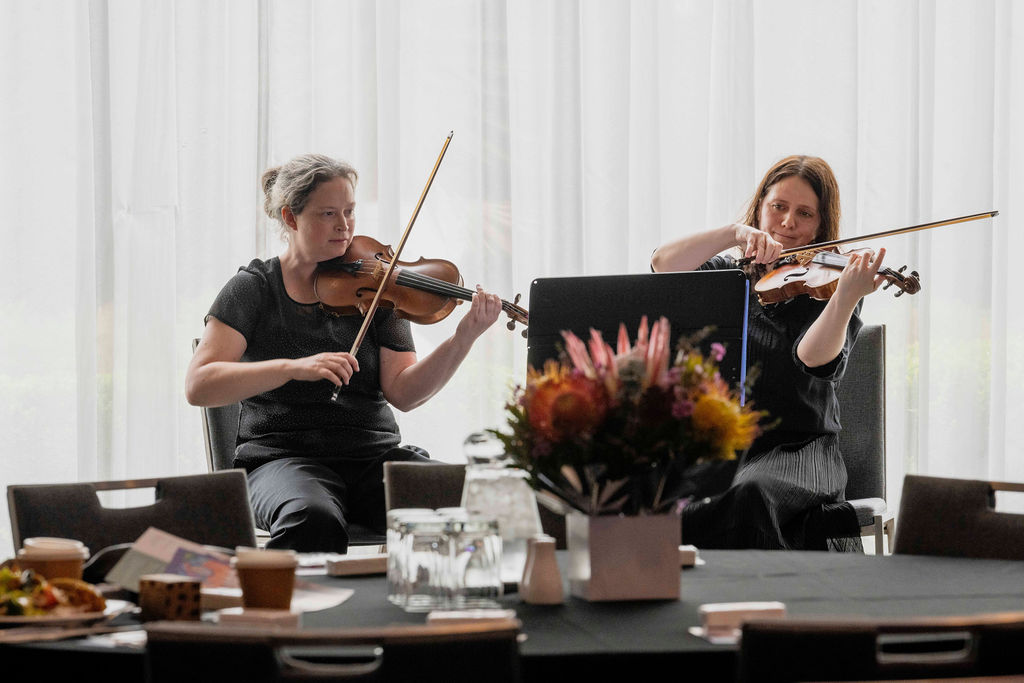 Two people playing the violin