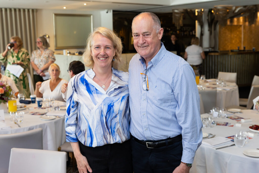 Two people standing and posing for a photo