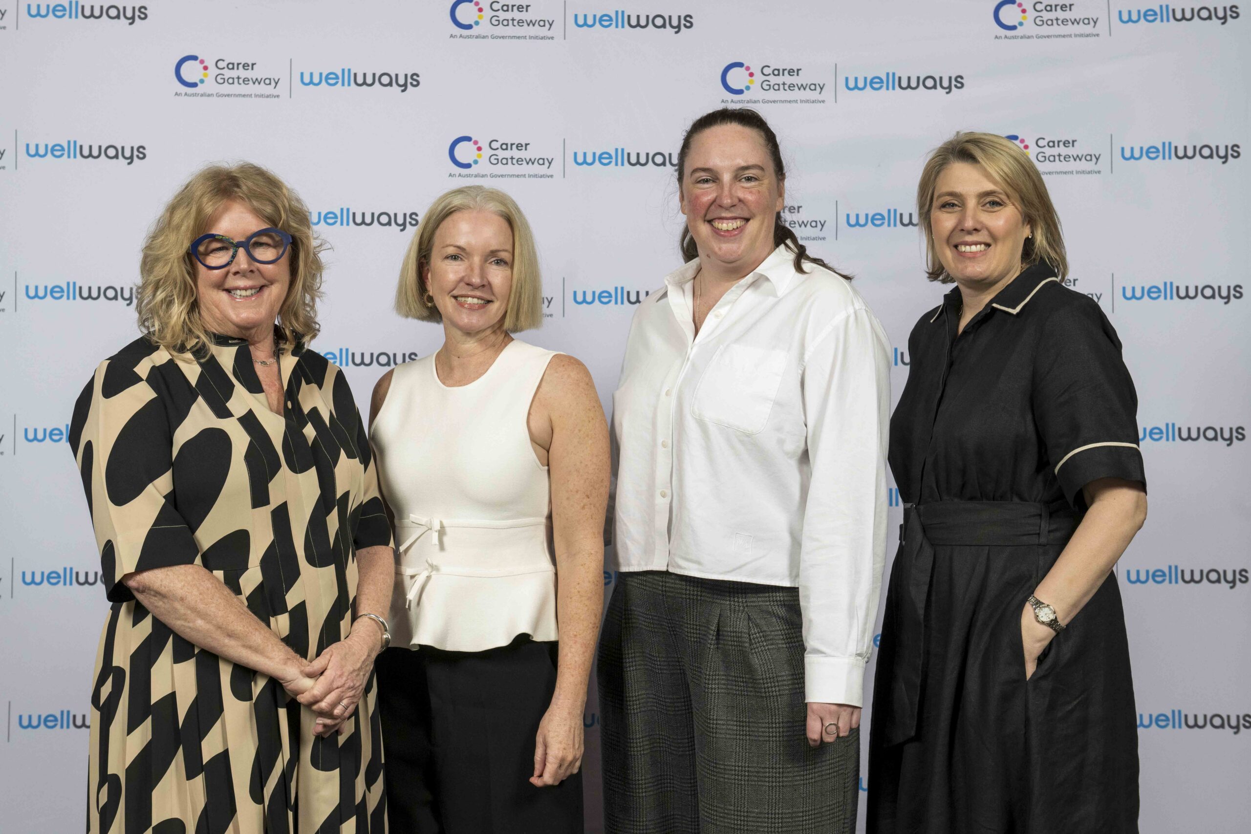 Four women standing and posing for a photo