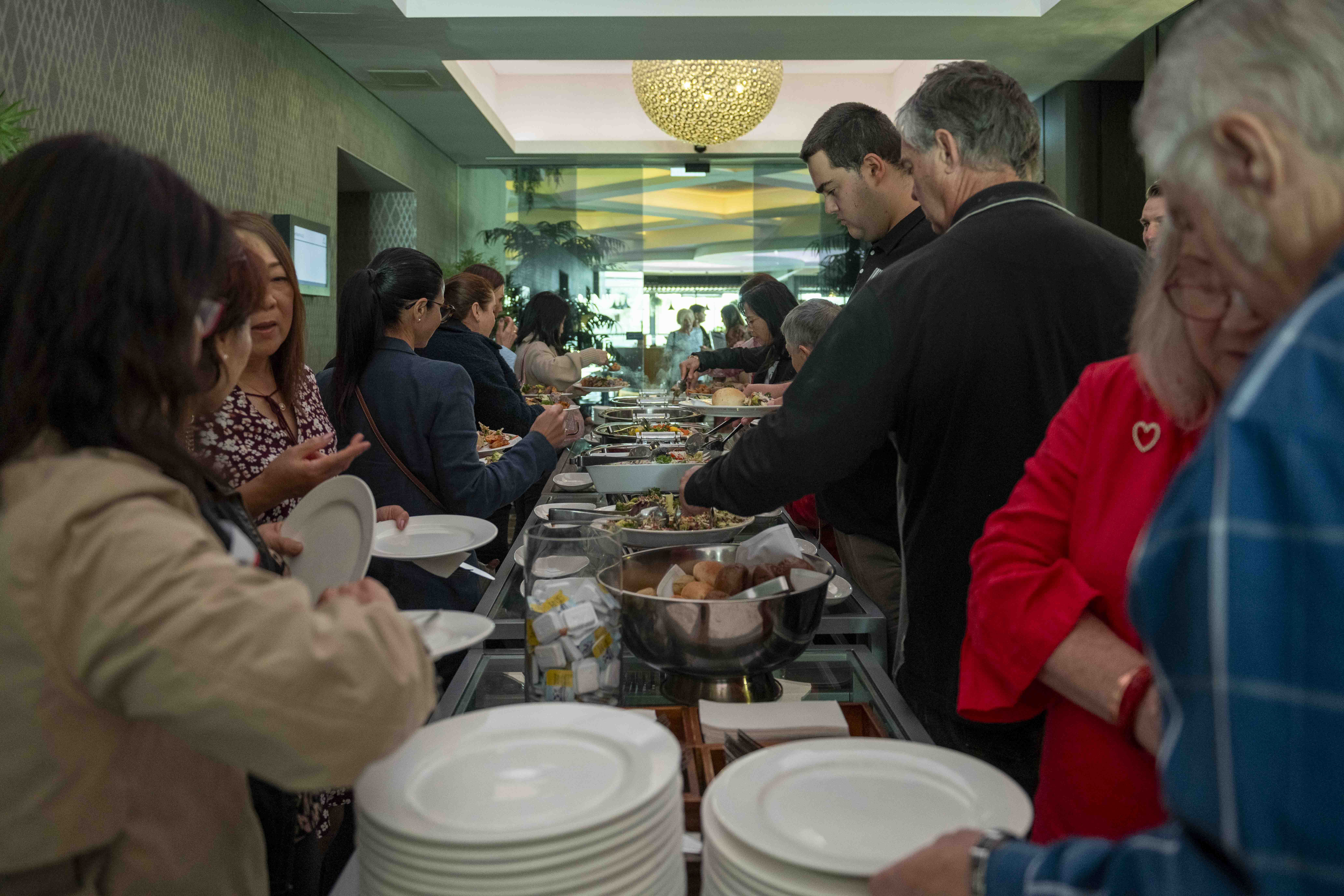 People line up around a buffet