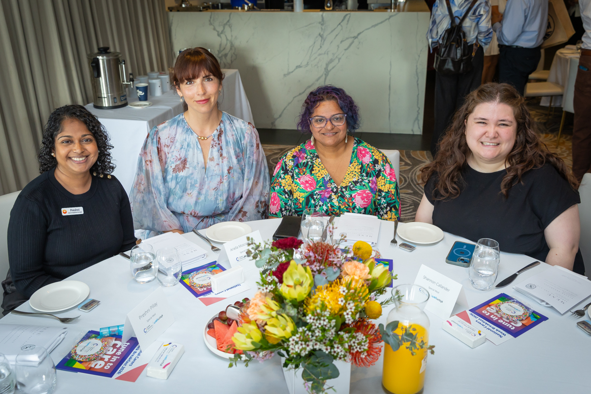 Four people sitting around a table